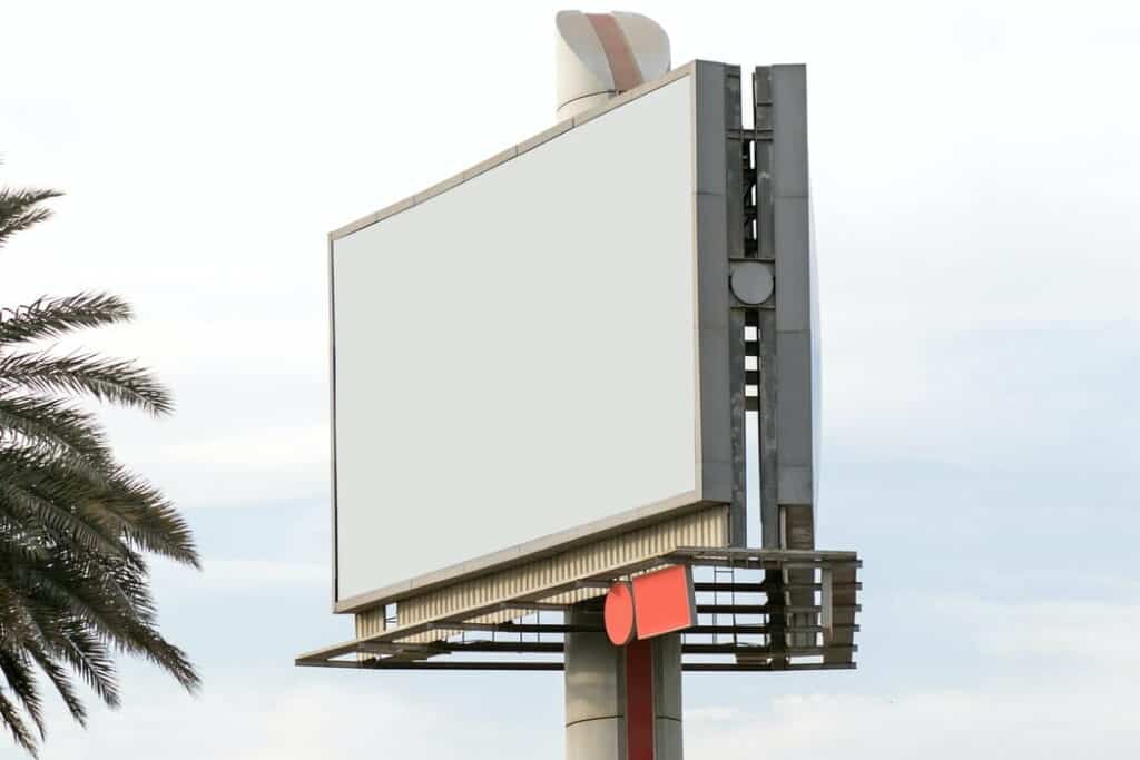 A blank billboard overlooking a highway.