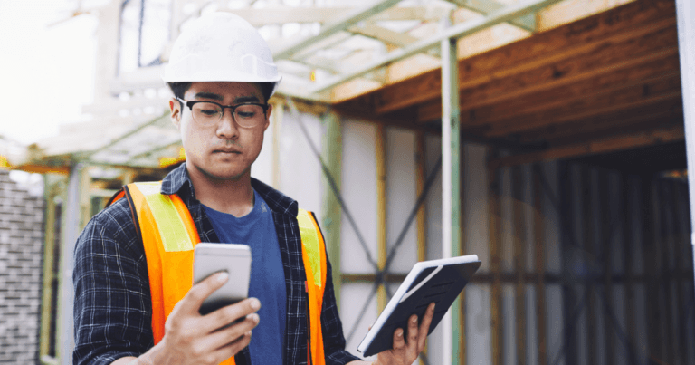 contractor texting on smartphone
